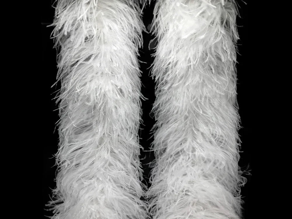 Fluffy white ostrich feathers for fashion and DIY crafts against a black background.