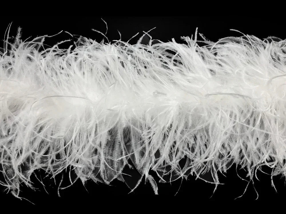 Fluffy white ostrich feathers for fashion and DIY crafts against a black background.