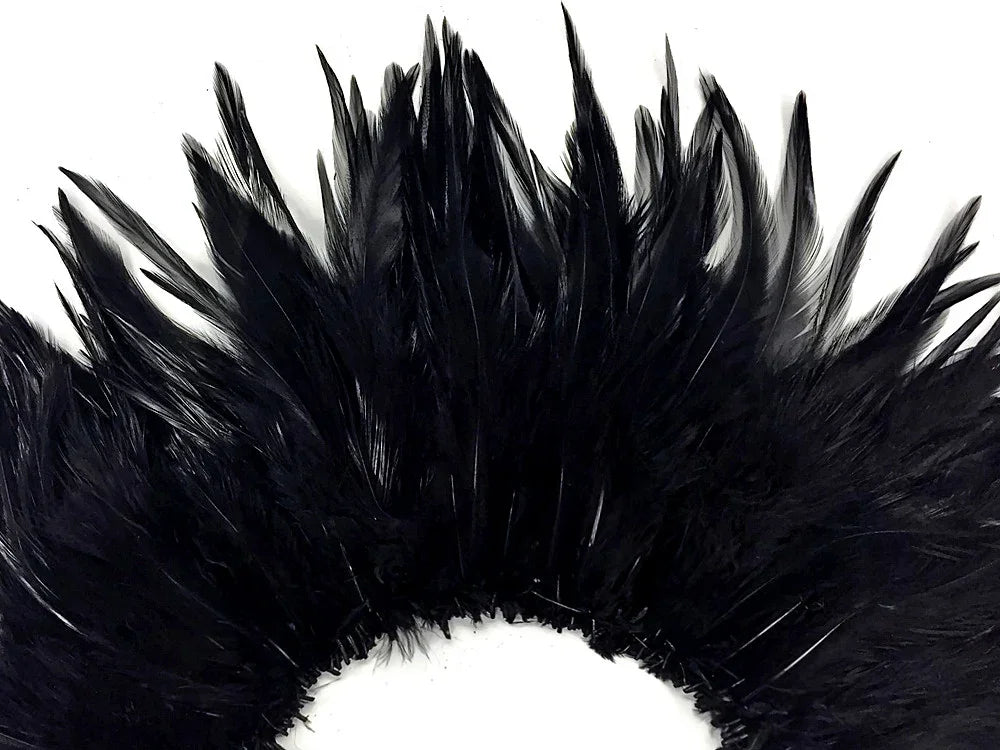 Lush black feathers arranged in a decorative fan shape for crafts and fashion DIY.