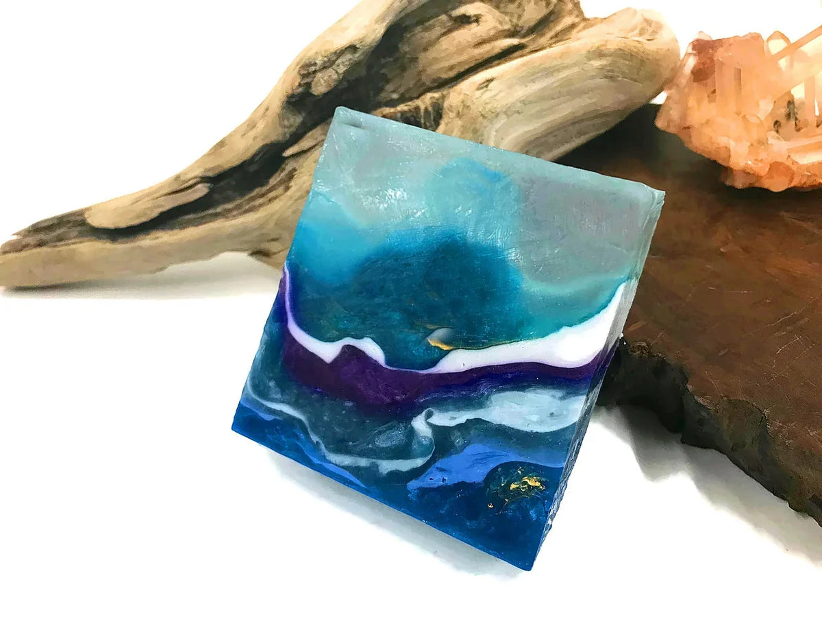 Blue and purple resin art tile with swirling ocean wave patterns and gold accents.