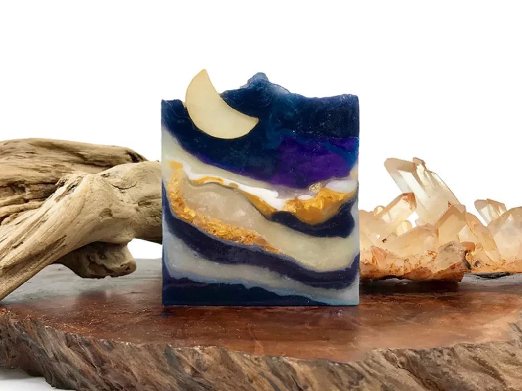 Artisan handmade soap bar with celestial moon and gold swirl design.