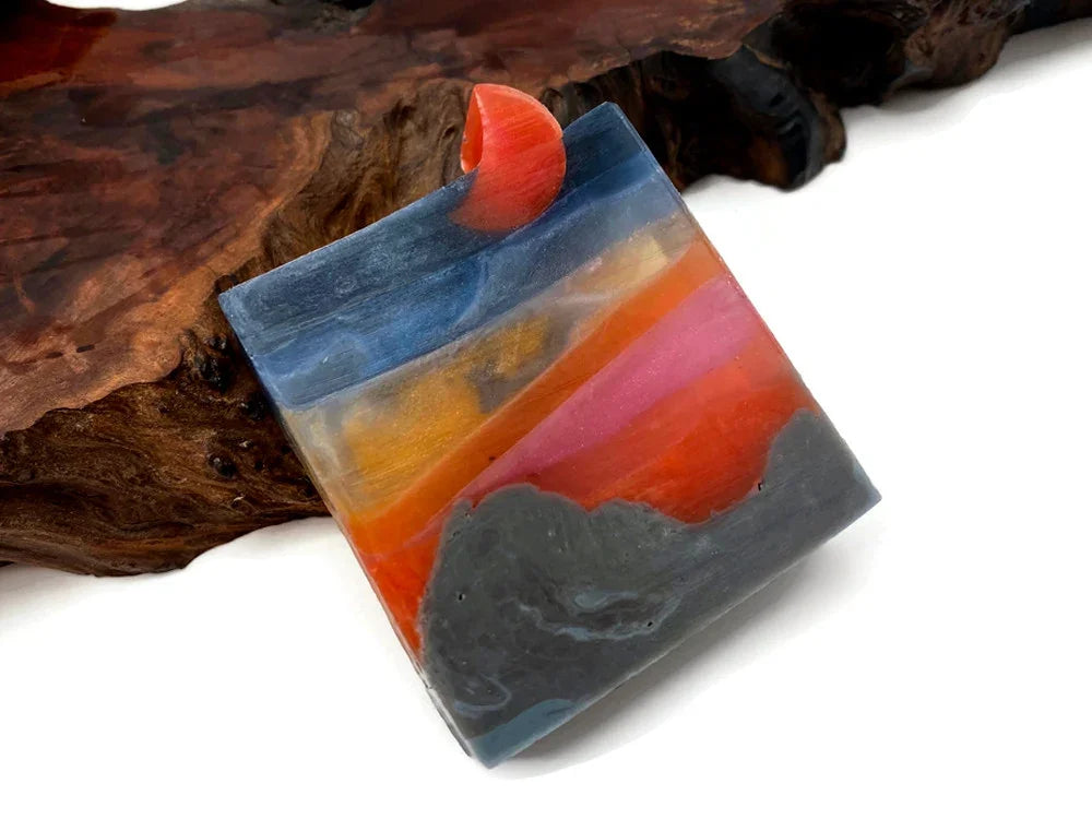 Colorful abstract resin art piece with blue, orange, and pink layers on a wooden base.