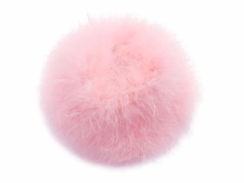Soft pink fluffy feather pompom for DIY crafts and fashion accessories.
