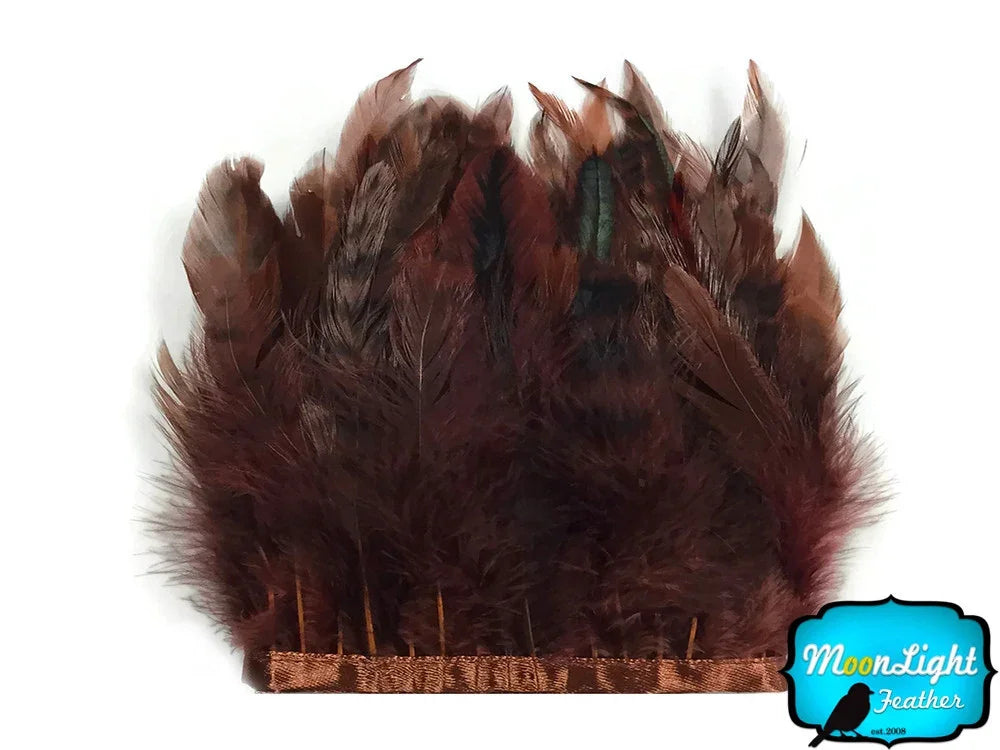 Dark brown ostrich feathers attached to a decorative headband for fashion and crafts.
