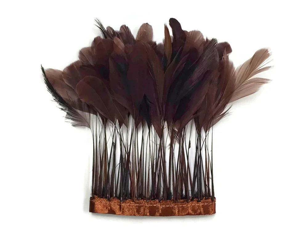 Dark brown natural feathers attached to a decorative hair comb for fashion accessories.