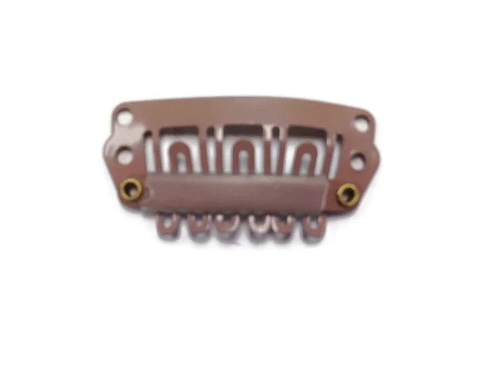 Copper-toned metal craft accessory with decorative cutouts and mounting holes