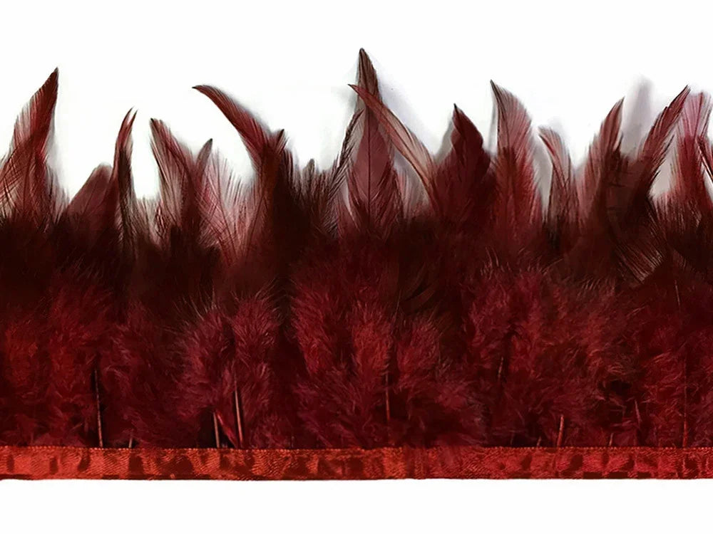 Deep burgundy ostrich feathers arranged in a dense, decorative fringe.