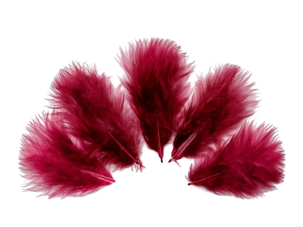 Vibrant magenta red feathers for DIY crafts and fashion decor on a white background
