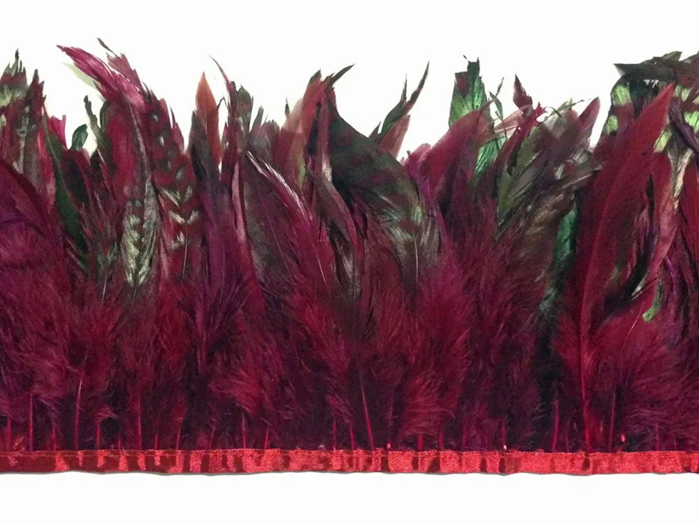 Deep burgundy and emerald green dyed feathers on a red trim for craft and fashion DIY.