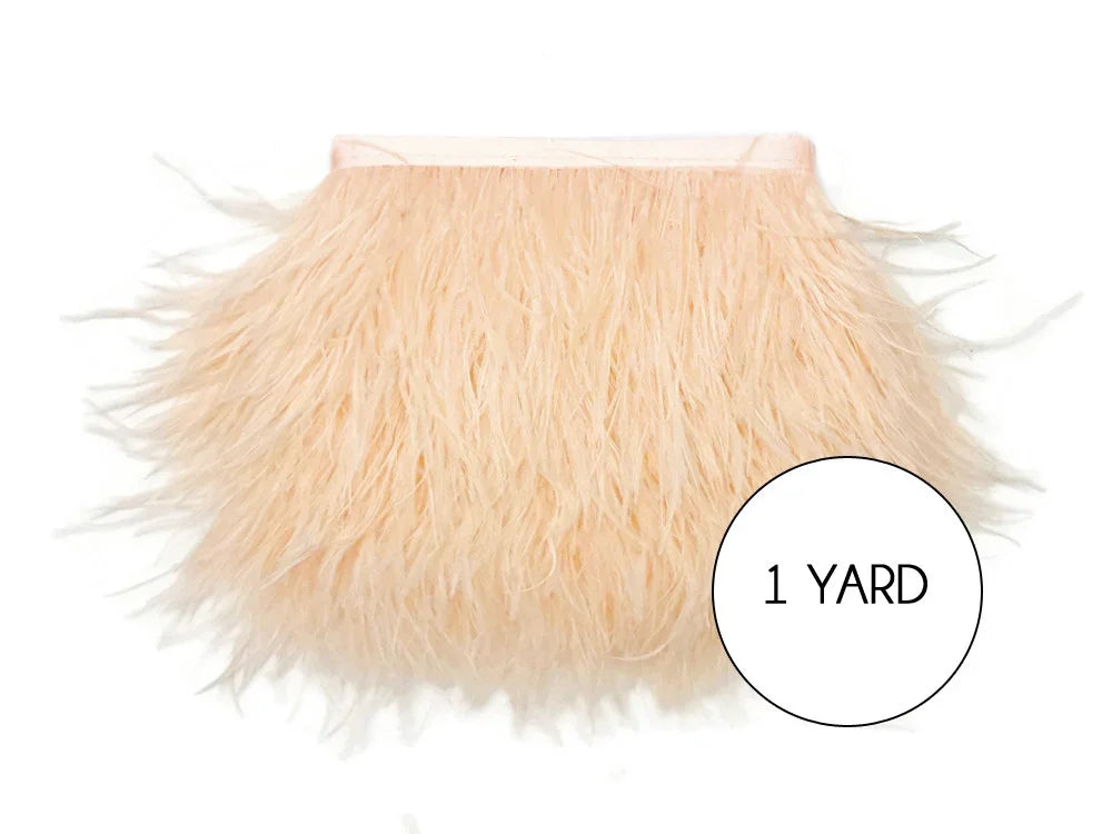 One yard of soft peach ostrich feather trim for DIY fashion and craft decor.
