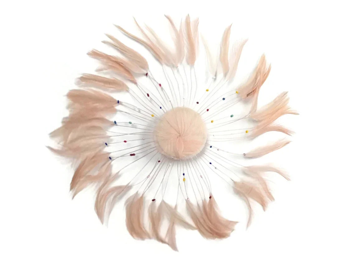 Elegant peach-colored feather hair accessory with delicate decorative accents.