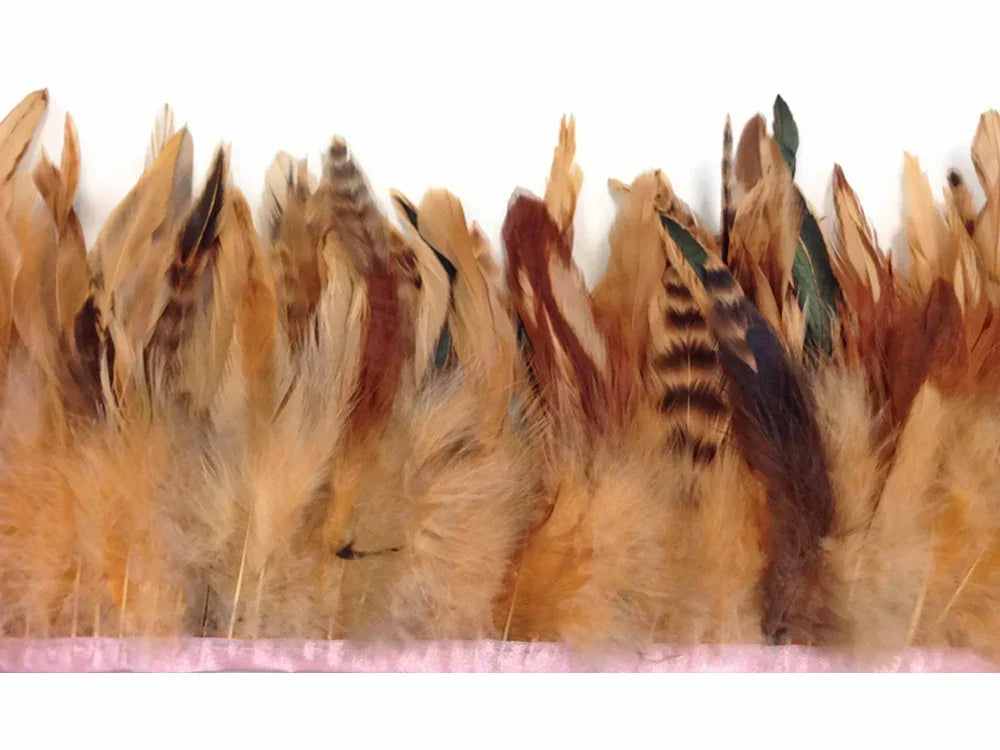 Natural brown and tan variegated feathers attached to a pink ribbon trim for DIY crafts.