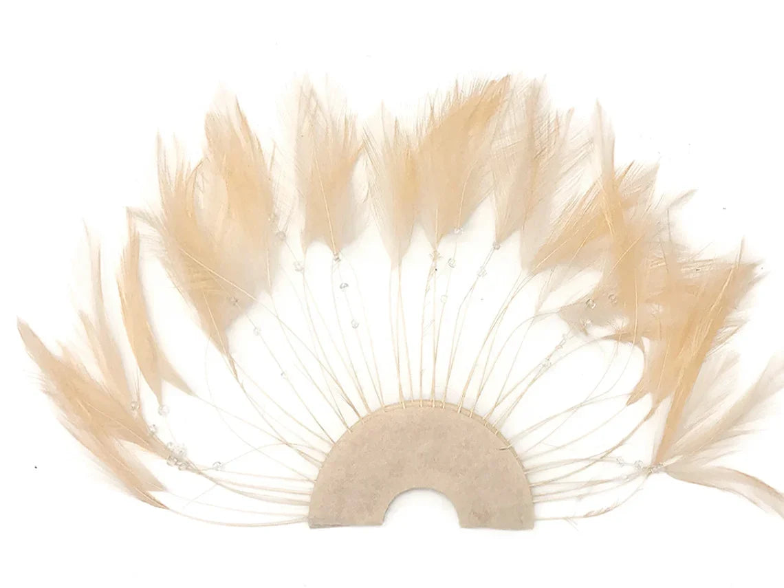 Cream-colored decorative feathers arranged in a fan shape for DIY crafts and fashion accessories.