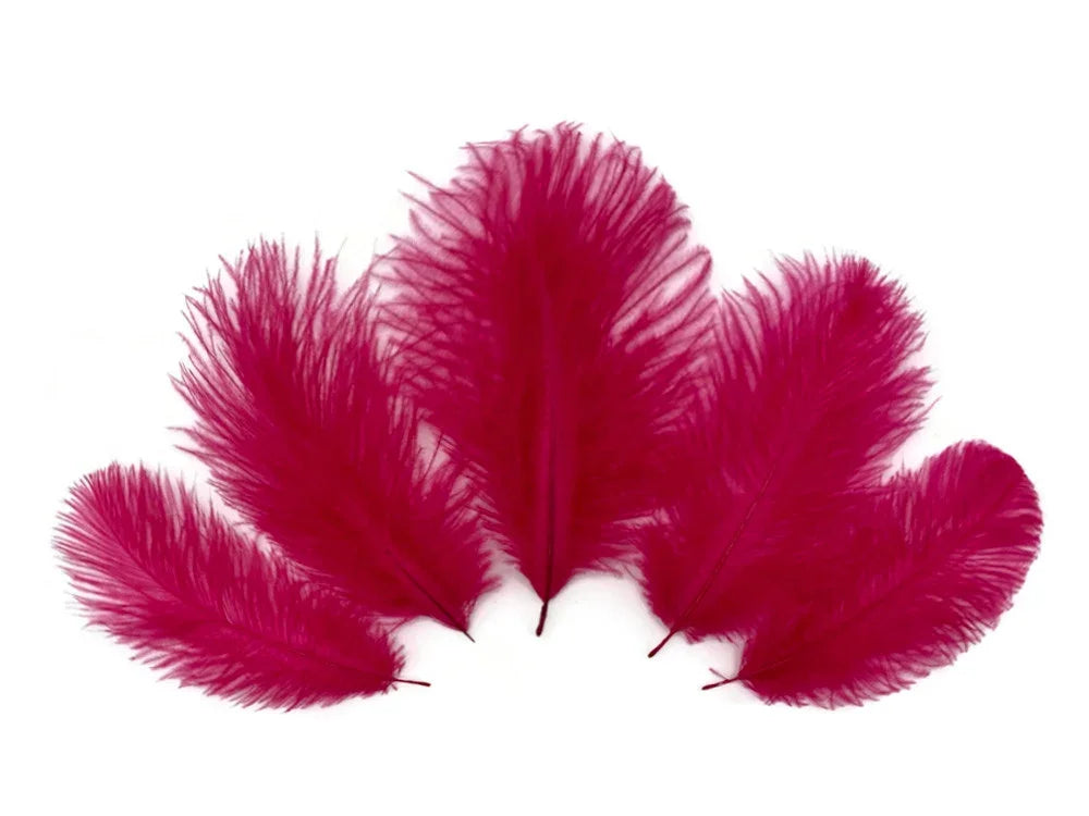 Vibrant magenta dyed feathers for DIY crafts and fashion decor on a white background.