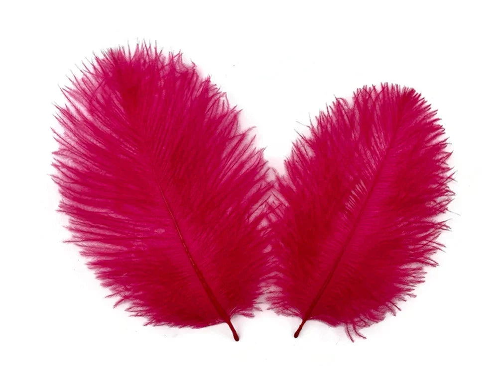 Two vibrant magenta ostrich feathers for DIY crafts and fashion decor on a white background.