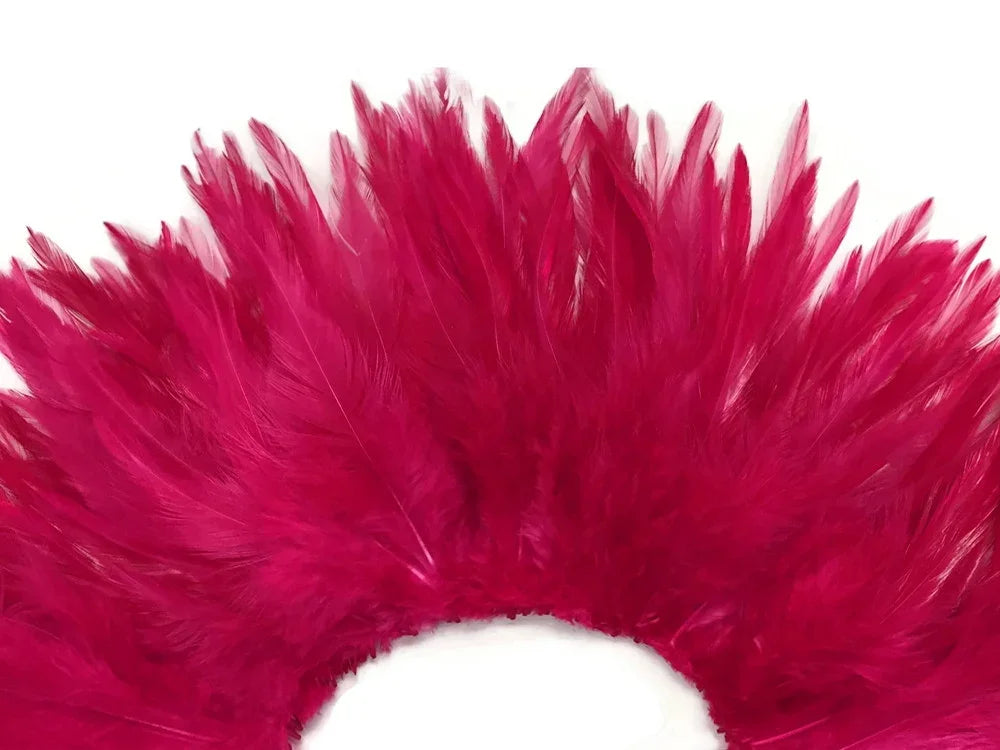 Vibrant magenta pink feathers arranged in a decorative fan shape for crafts and fashion.