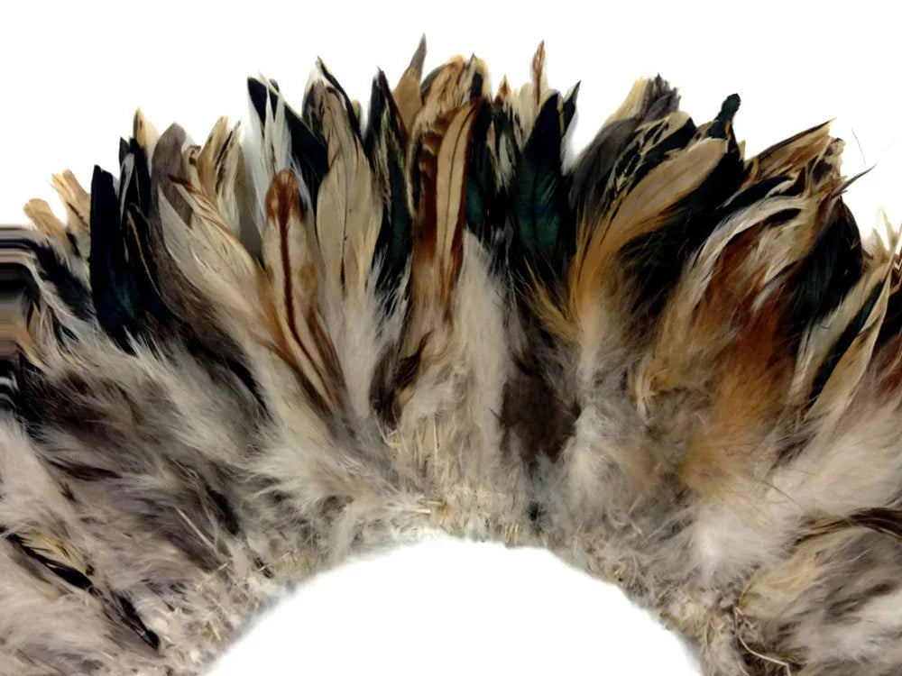 Natural multicolored craft feathers in brown, cream, and teal for DIY fashion and decor.