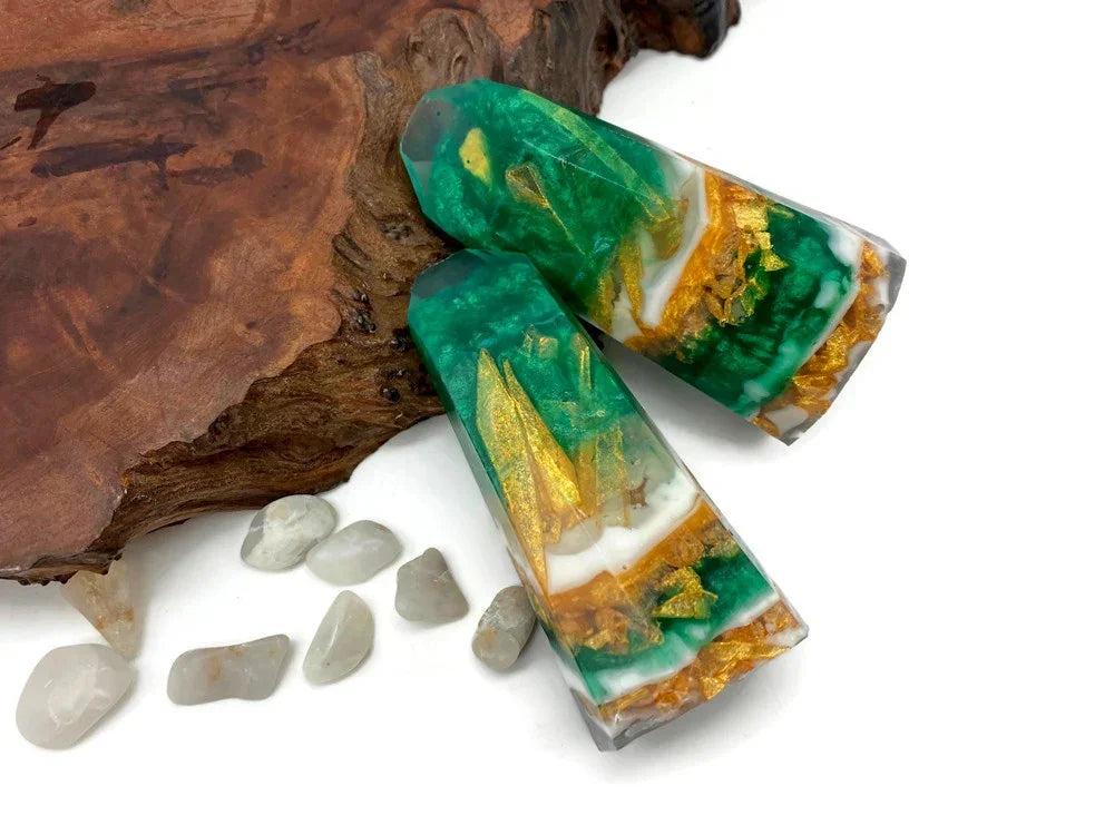 Green resin crystals with gold leaf accents and white marble swirls on a wood base.