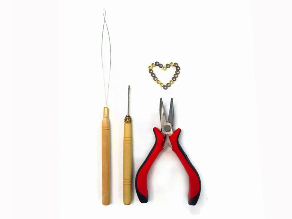 Jewelry making tools including pliers, wire loops, and a heart-shaped bead arrangement.