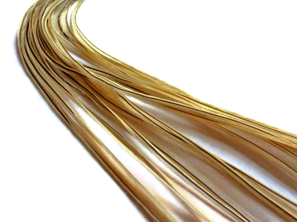Golden shimmering feather strands for fashion and DIY crafts on a white background.