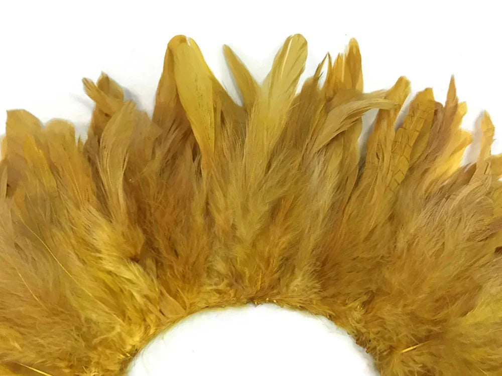 Close-up of gold colored craft feathers arranged in a decorative curved fan shape