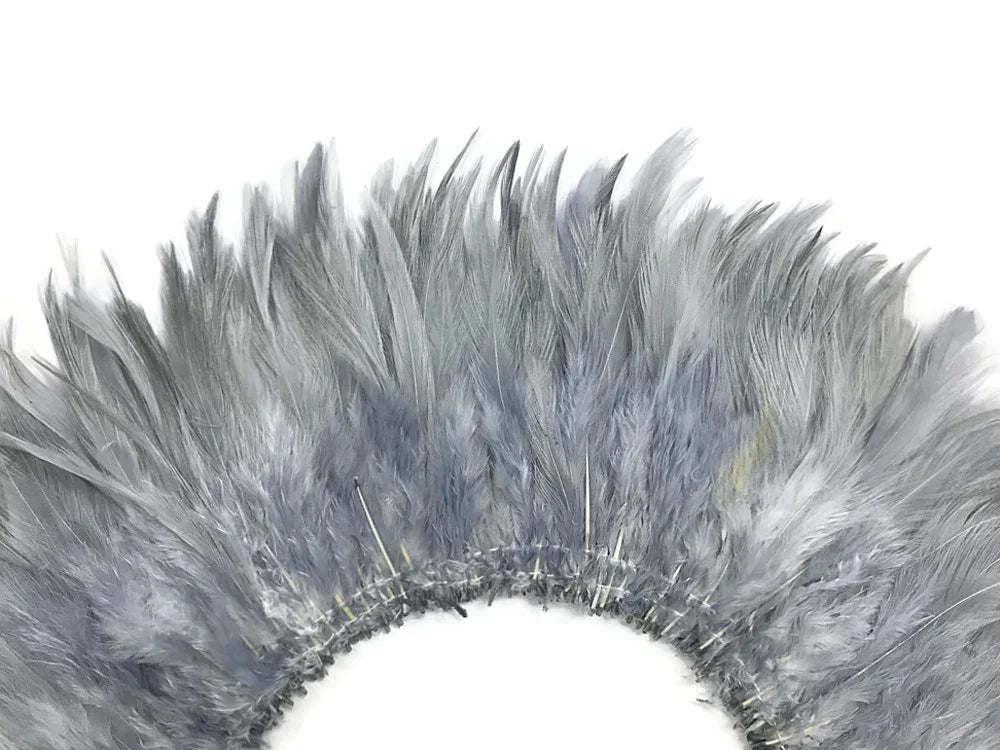 Grey ostrich feathers arranged in a decorative circular plume for fashion and DIY crafts.