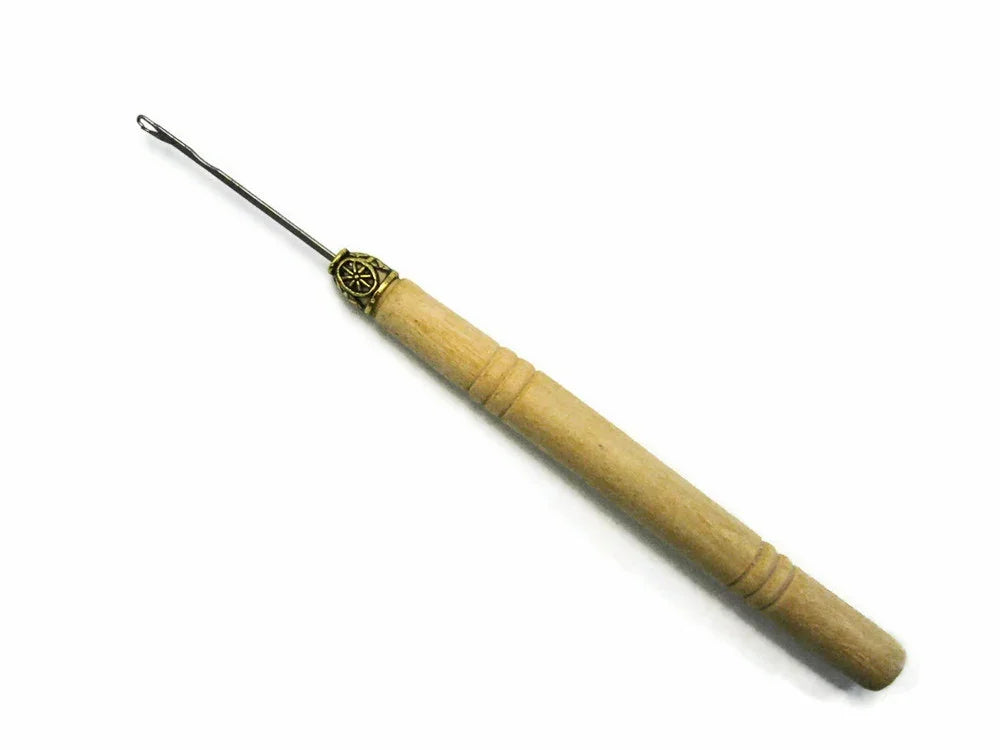 Wooden handle feather crafting tool with metal needle tip on white background