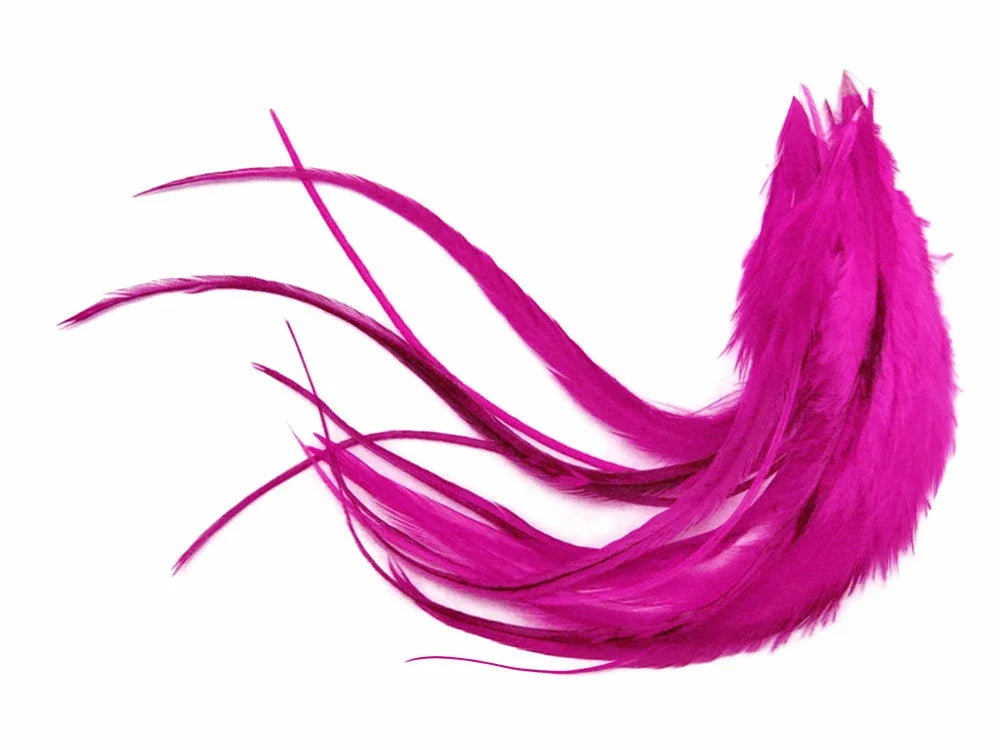 Vibrant magenta pink feathers for DIY crafts and fashion accessories on a white background.