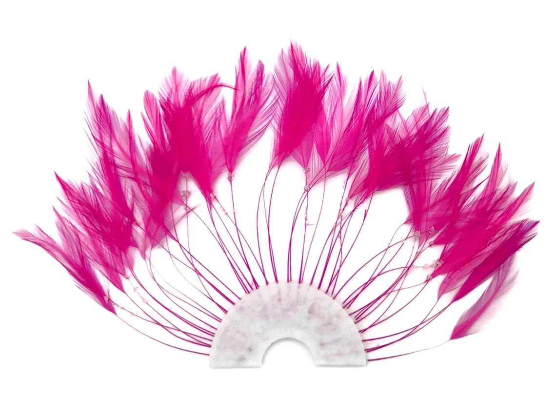 Vibrant pink dyed feathers arranged in a fan shape on a white semi-circle base for crafts.