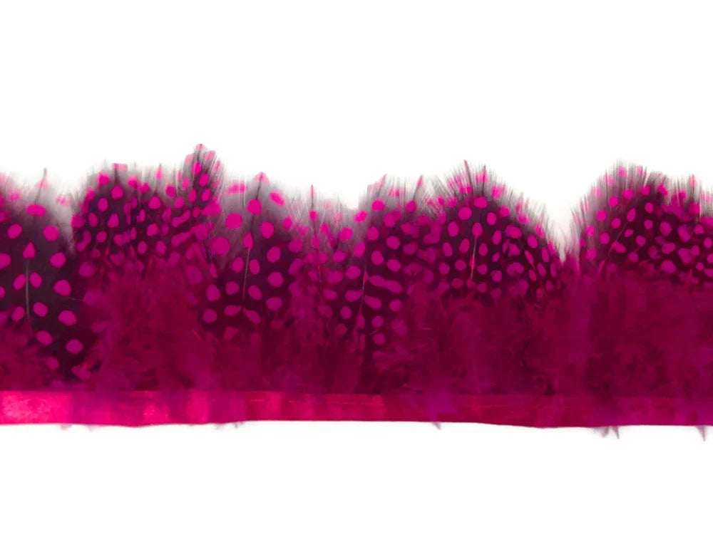Vibrant magenta pink spotted feather trim for fashion and DIY crafts.
