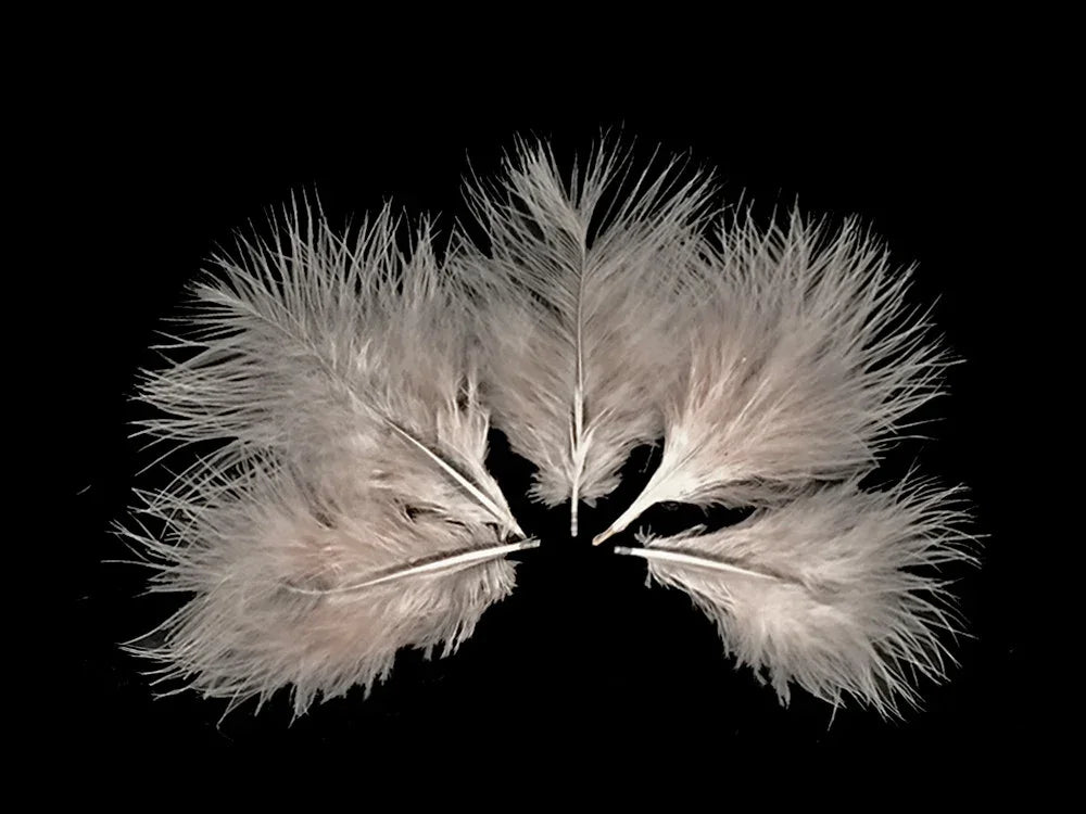 Soft white fluffy feathers for DIY crafts and fashion décor against a black background.