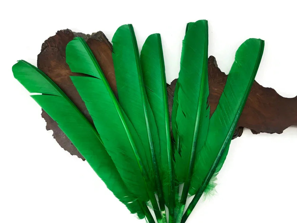 Vibrant green craft feathers arranged on a dark wooden background for DIY decor.