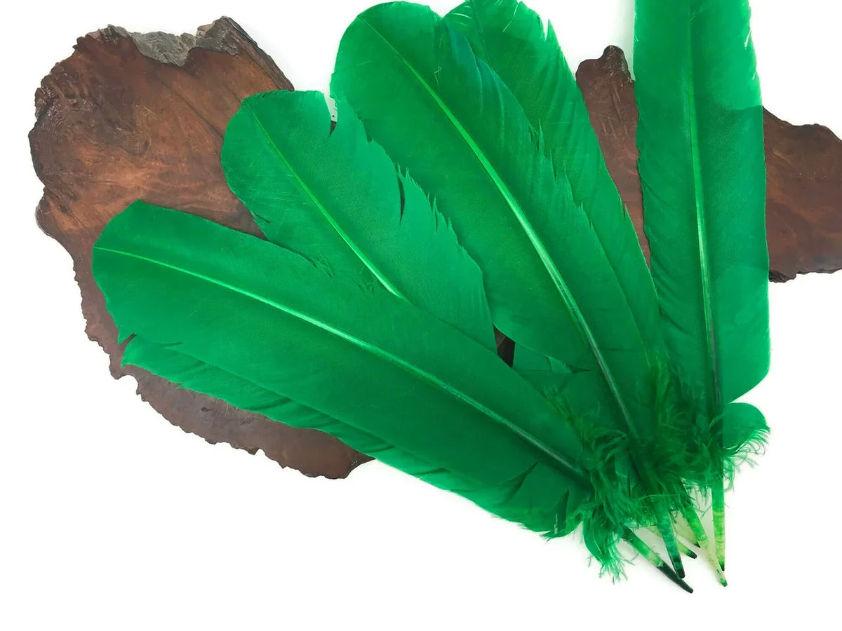 Vibrant green feathers for DIY crafts and fashion accessories on a rustic wood background.