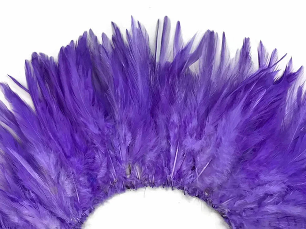 Vibrant purple feathers arranged in a decorative fan shape for crafts and fashion.