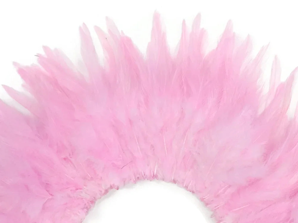 Soft pink feathers arranged in a decorative fan shape for crafts and fashion DIY.