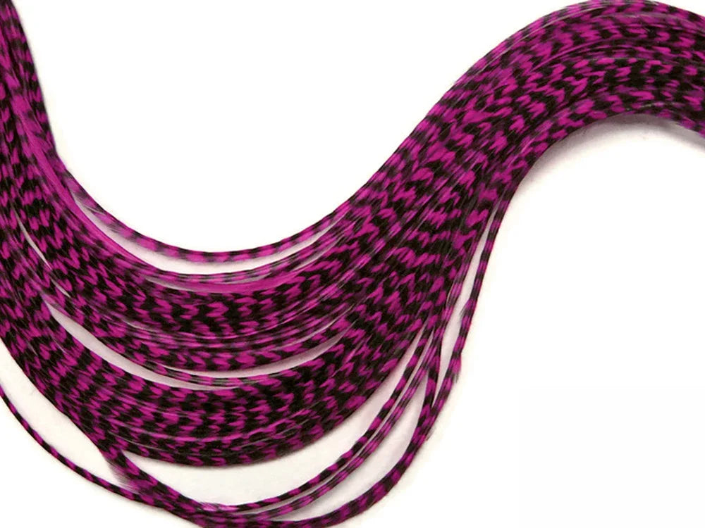 Pink and black patterned feather hair extensions for DIY crafts and fashion.