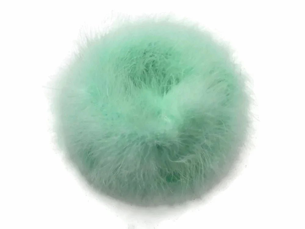 Soft mint green fluffy feather pom pom for DIY crafts and fashion accessories.
