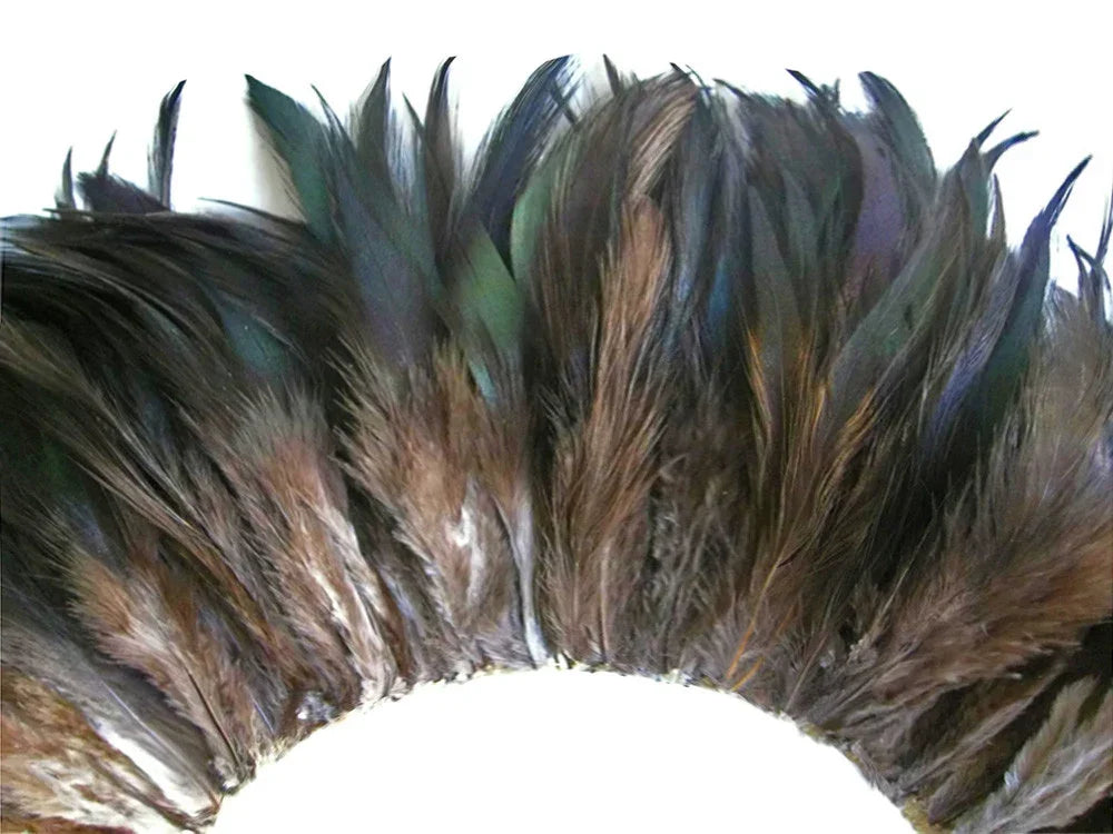 Iridescent brown and teal craft feathers arranged in a decorative arch pattern.