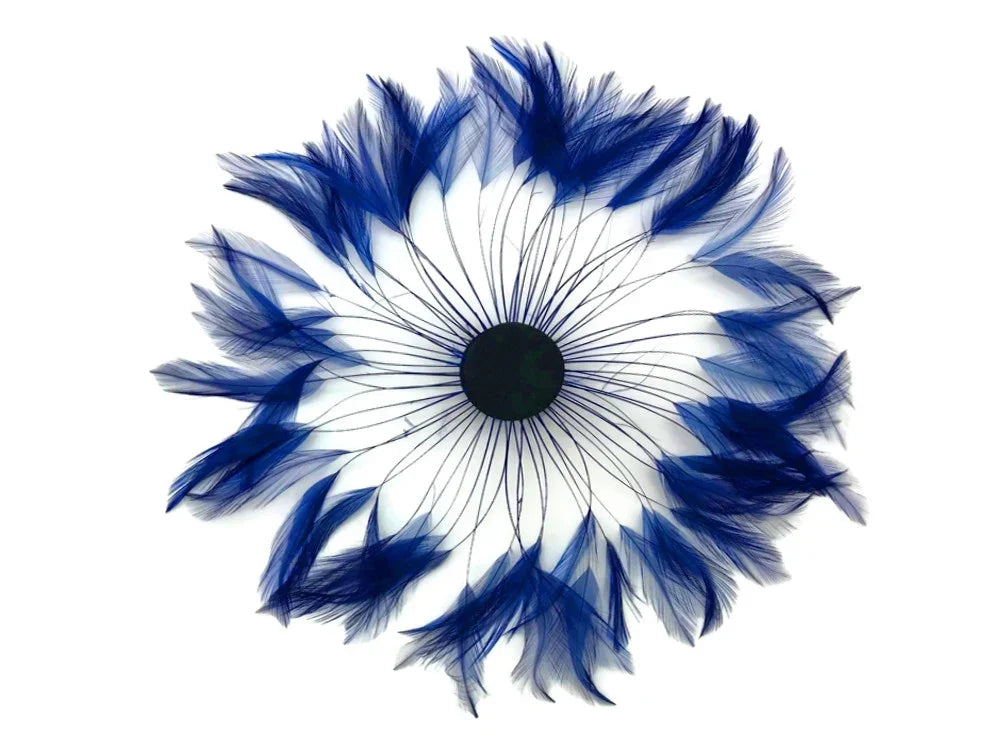 Vibrant blue feathers arranged in a circular floral pattern for DIY crafts and fashion decor.