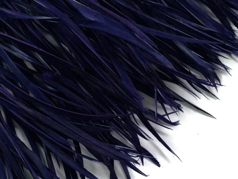 Deep navy blue dyed feathers for DIY crafts and fashion accessories.