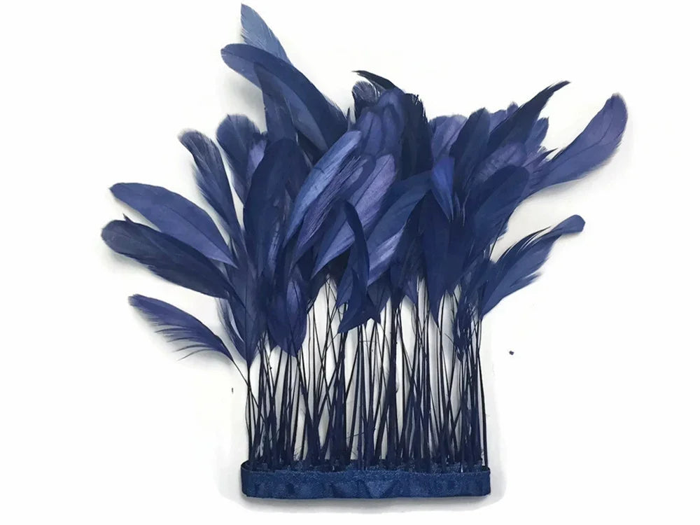 Deep navy blue feathers on thin stems for DIY crafts and fashion accessories.