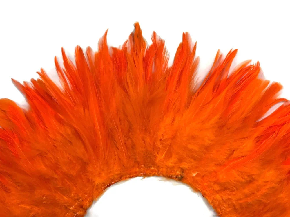 Vibrant orange feathers arranged in a decorative fan shape for crafts and fashion.