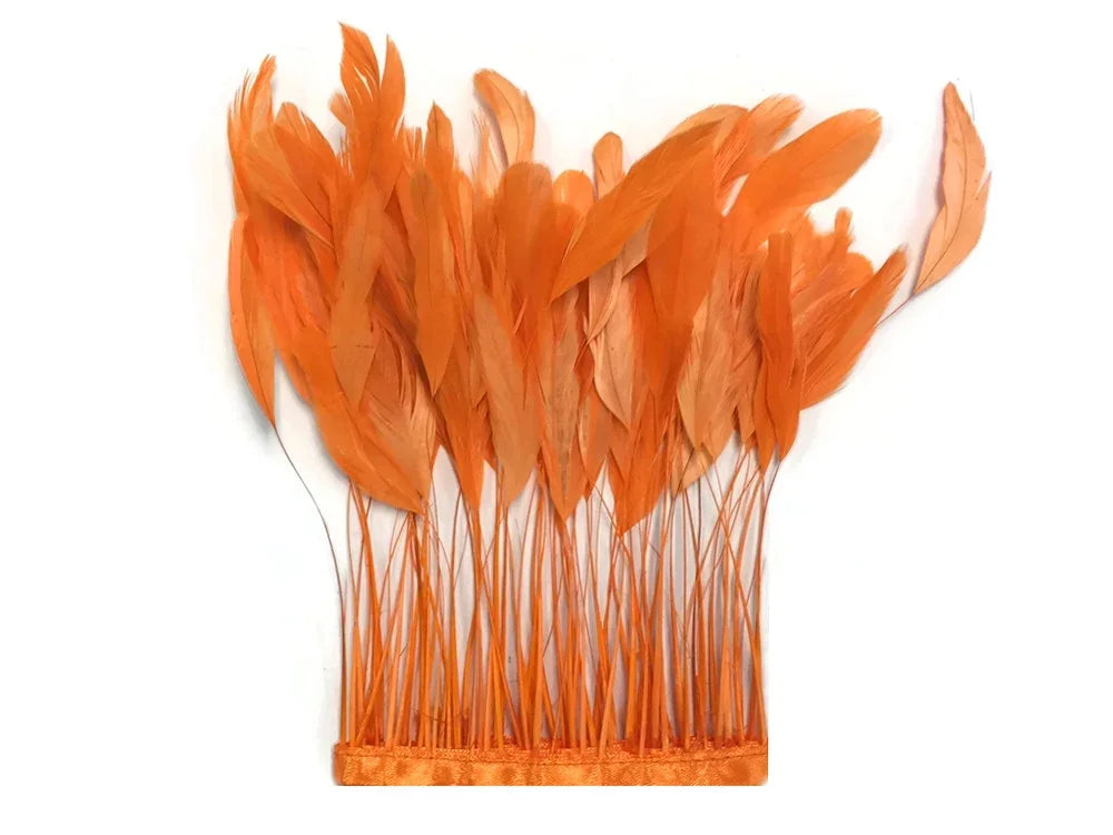 Vibrant orange feathers arranged for DIY fashion and craft décor.