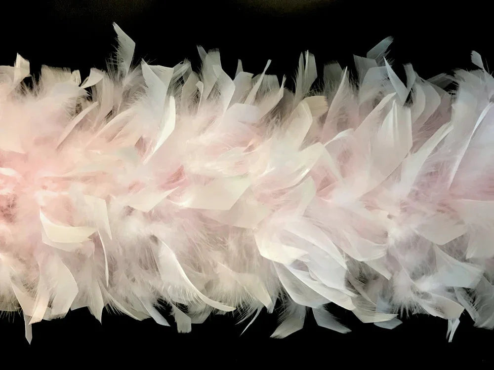 Soft pale pink feather boa for fashion accessories and DIY craft decor.