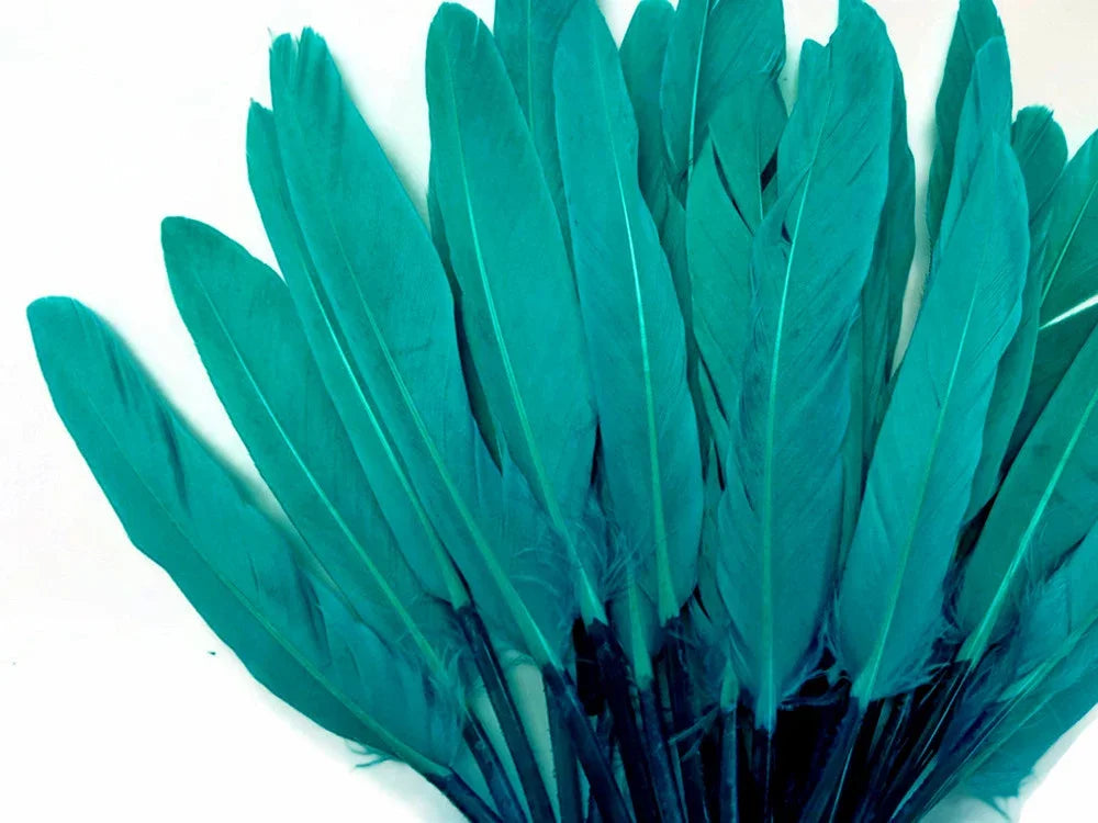 Vibrant teal blue craft feathers for DIY fashion and décor projects.