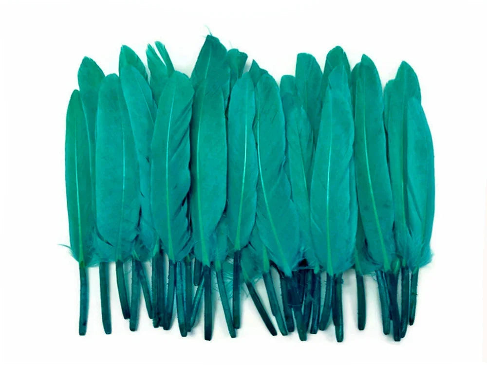 Collection of vibrant teal dyed craft feathers for DIY fashion and decor.