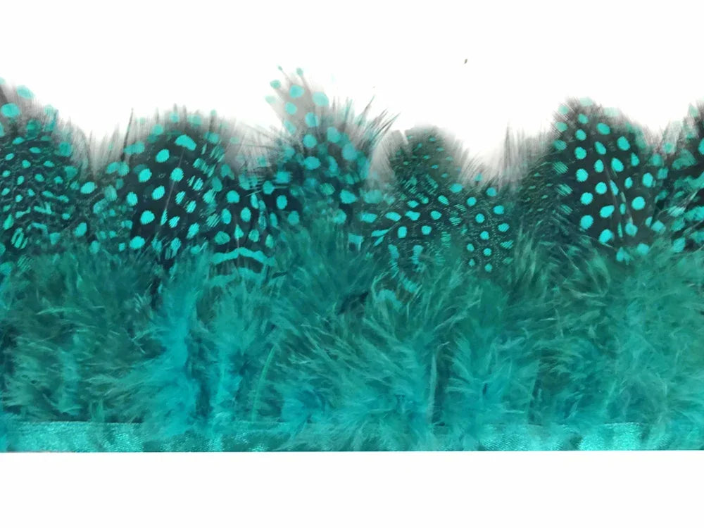 Vibrant teal ostrich feathers with black polka dot patterns for crafts and fashion DIY.