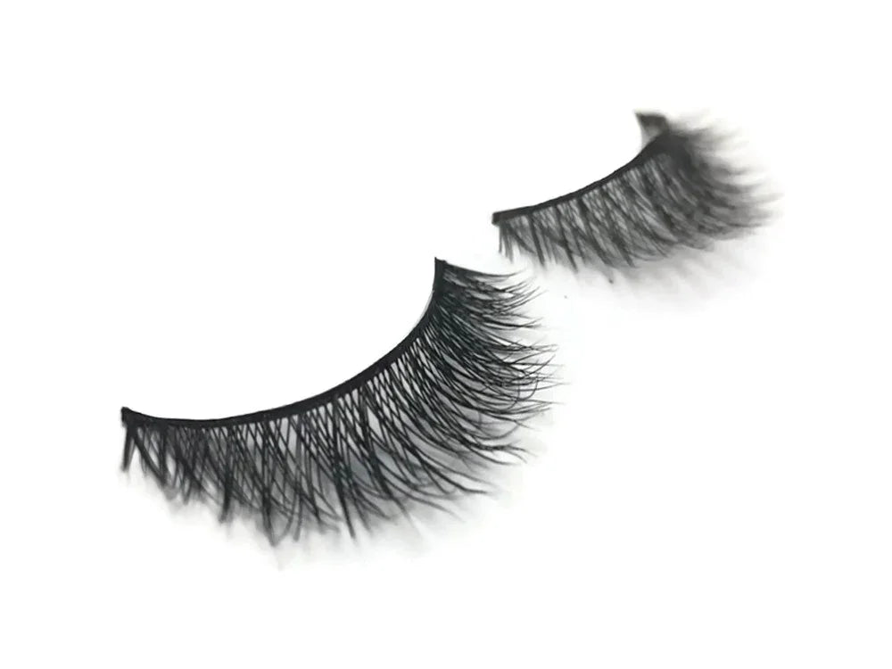Pair of long, voluminous black false eyelashes on a white background.