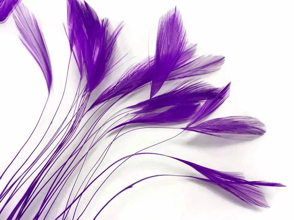 Vibrant purple dyed feathers for DIY crafts and fashion accessories on a white background.