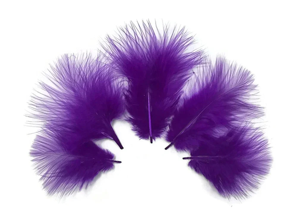 Three vibrant purple feathers for DIY crafts and fashion décor on a white background.